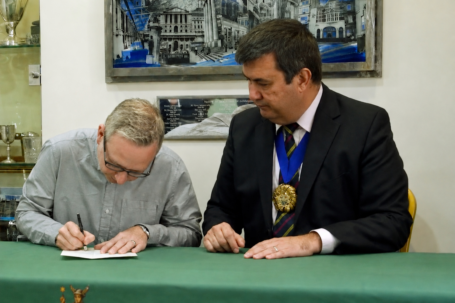 Stefan Fafinski and Simon Gunning (CEO CALM) signing the grant for the WCIT Charity Award 2018.